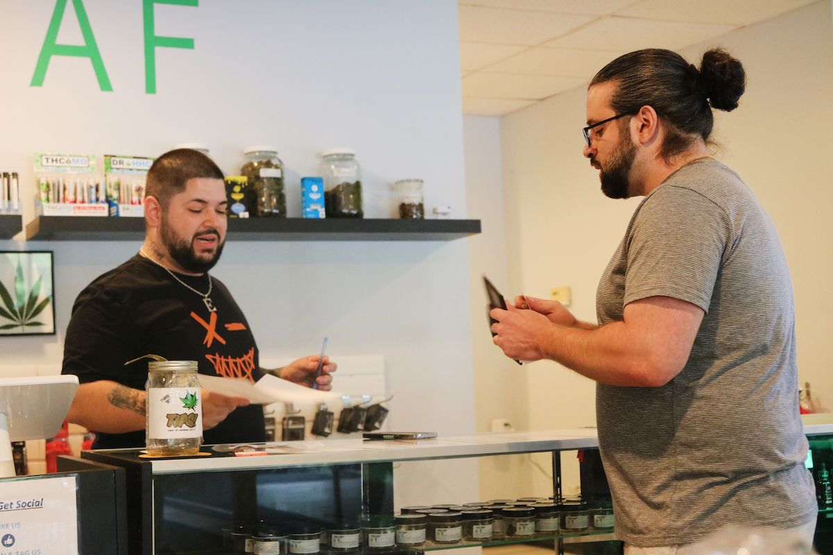 Manager Victor Quinones interacting with customers at Leaf  & Fog on Doubleday Avenue in Milton.